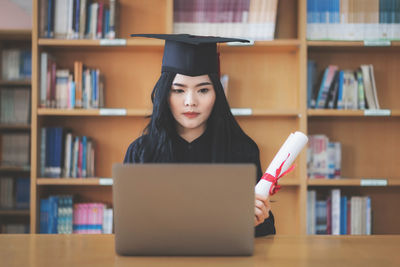 Portrait of young woman reading book