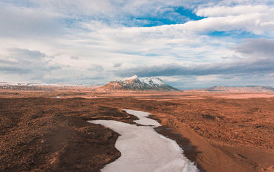 View of landscape against cloudy sky