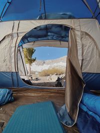 Tent in water against blue sky