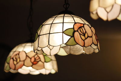 Close-up of illuminated lighting equipment against black background