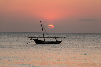 Silhouette boat on sea against sky during sunset