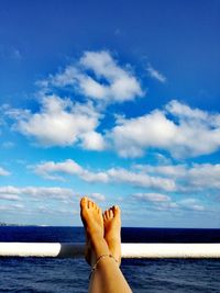 Low section of man in sea against sky