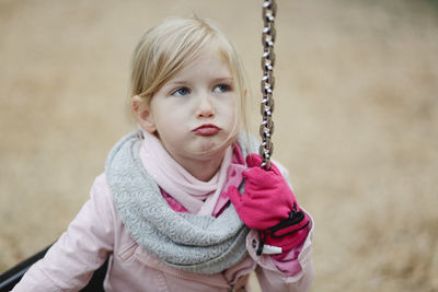 High angle view of girl on swing at park