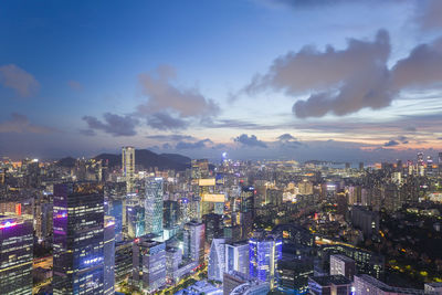 High angle view of illuminated city buildings against sky