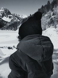 Rear view of man and woman standing on snow