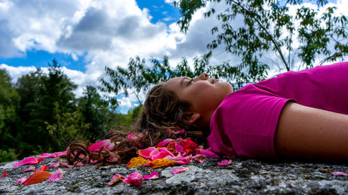 Sleeping girl with a happy face on a stone