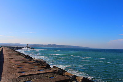 Scenic view of sea against clear blue sky