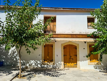 Exterior of mediterranean house with tree against sky