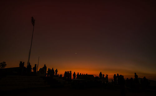 Silhouette people against sky during sunset