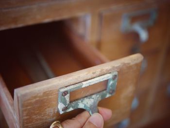 Close-up of person hand opening drawer