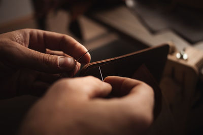 Cropped hand of person using mobile phone