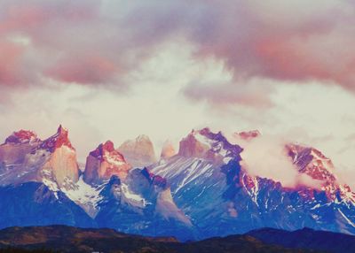 Scenic view of mountains against cloudy sky