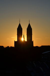 Silhouette temple against sky during sunset