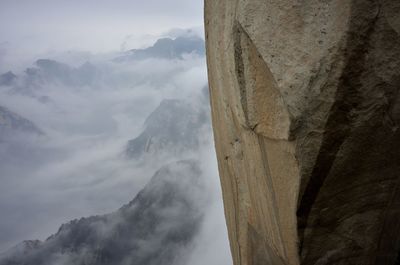 Scenic view of mountains against cloudy sky