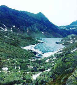 Scenic view of sea and mountains against sky