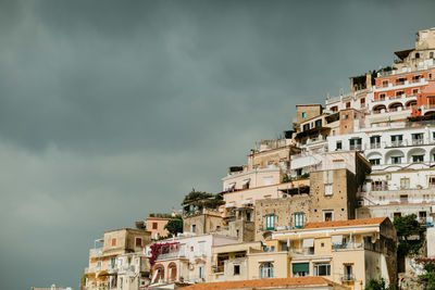 Houses in city against sky