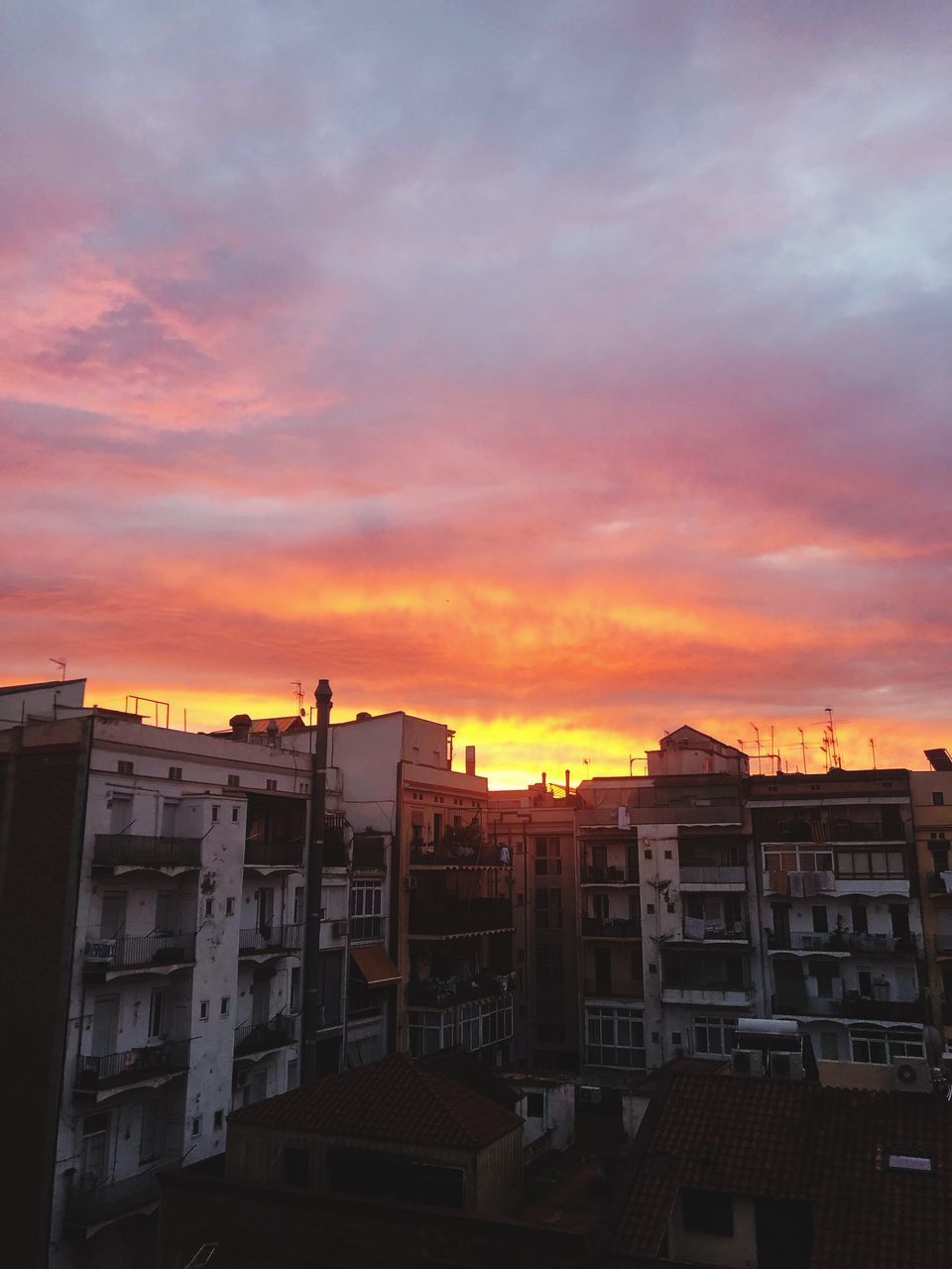 EXTERIOR OF RESIDENTIAL BUILDINGS AGAINST ROMANTIC SKY