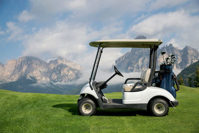View of golf course against mountain range