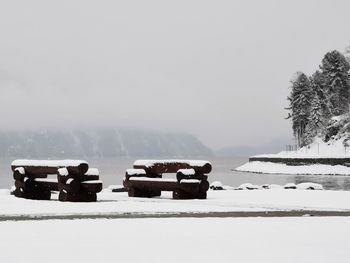 Scenic view of snow covered field against sky