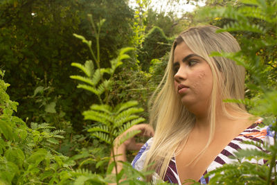 Portrait of woman with plants in park