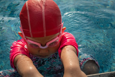 High angle view of girl swimming in pool