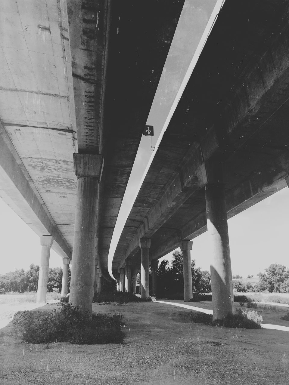 LOW ANGLE VIEW OF ELEVATED ROAD LEADING TOWARDS BRIDGE