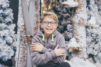 Portrait of a smiling boy in snow