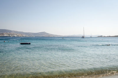 Sailboat sailing on sea against clear sky