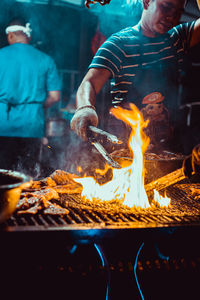 Man preparing food on barbecue grill