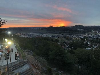 High angle view of people in city against sky during sunset