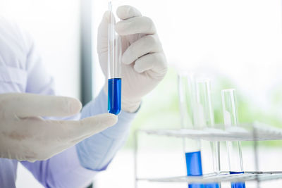 Cropped hands of scientist holding test tube in laboratory