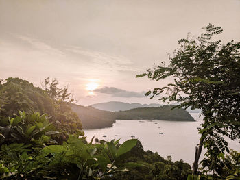 Scenic view of lake and mountains against sky