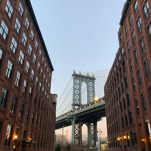 Low angle view of manhattan bridge against clear sky in city