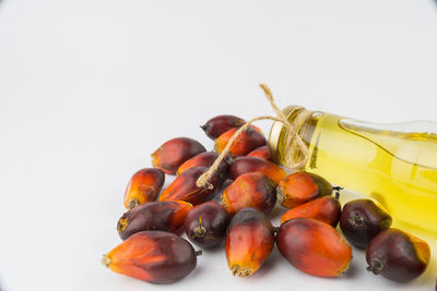 Close-up of fruits in plate against white background