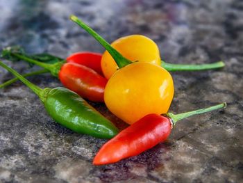 Close-up of tomatoes and chili peppers on table