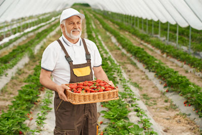 Man working in basket on field