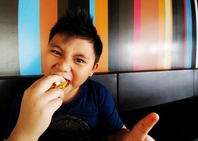 Portrait of boy eating food in restaurant