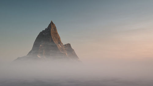 The peak of the mountain rises above the clouds. aerial view