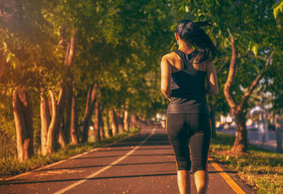 Full length of woman walking on footpath