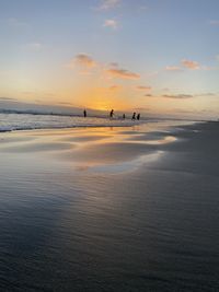 Scenic view of beach against sky during sunset