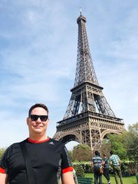 Portrait of man with tower against sky