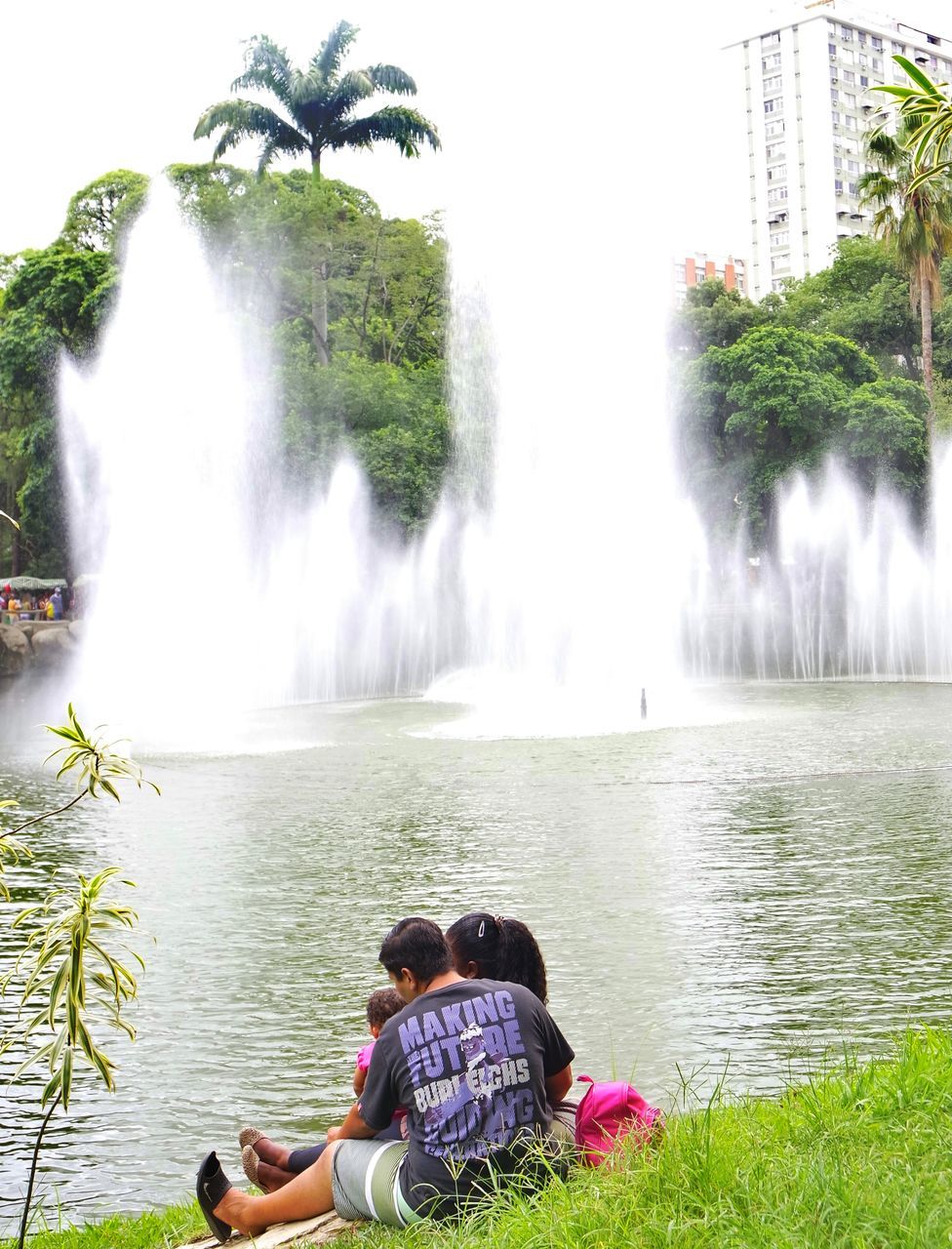 WOMAN ENJOYING WATERFALL