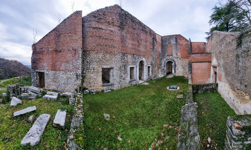 Low angle view of old ruins against sky