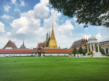 Temple by building against sky