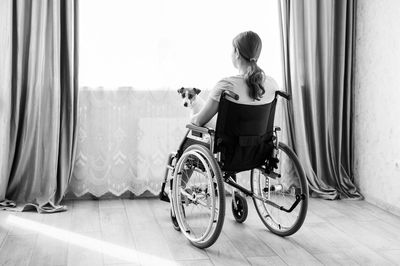 Side view of woman using mobile phone at home