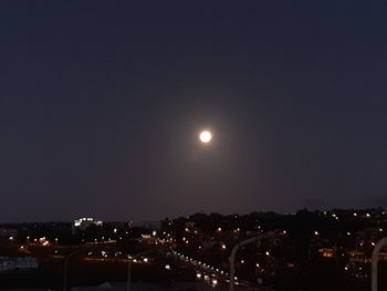 Illuminated city against sky at night