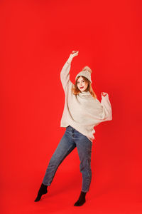 Portrait of smiling man against red background