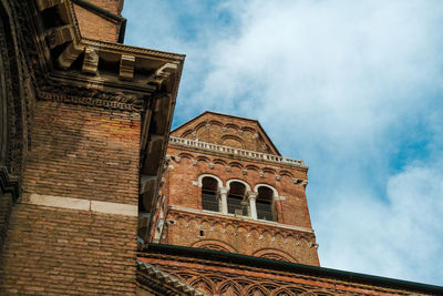View of church bell between buildings in venice, italy