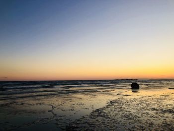 Scenic view of sea against clear sky during sunset