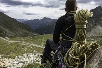 Rear view of man on rope against mountain range